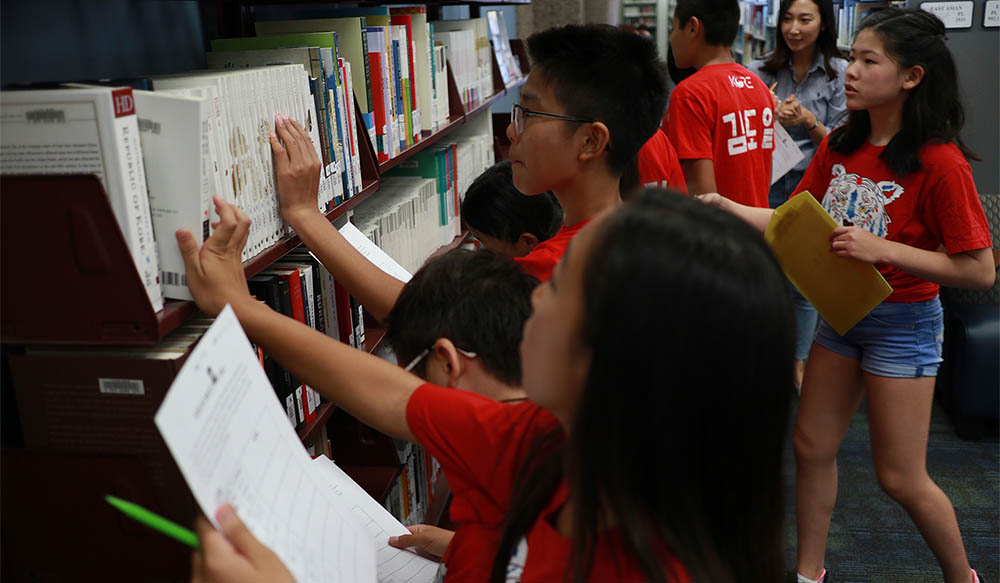 Local middle school Korean American students working on language class assignments