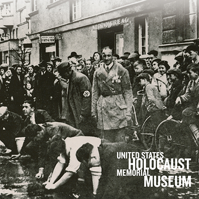 Nazi soldiers and German citizens standing over Jewish citizens in the street in Nazi Germany